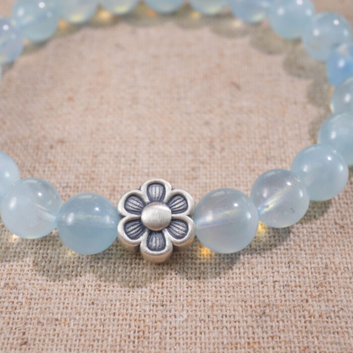 Close-up of Aquamarine Beads and Oxidized Silver Flower Charm