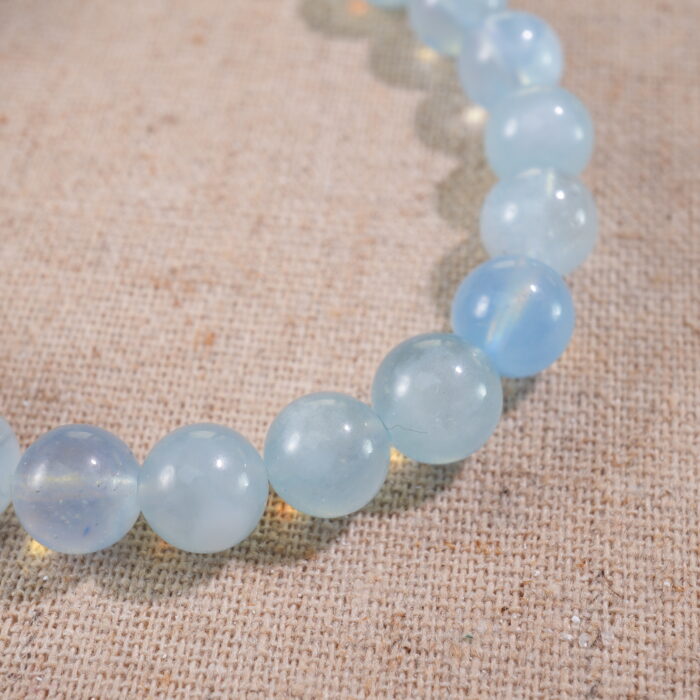 Close-up of Aquamarine Beads and Oxidized Silver Flower Charm