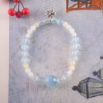 Feminine Bow Charm Bracelet with Aquamarine and Chalcedony in Soft Lighting
