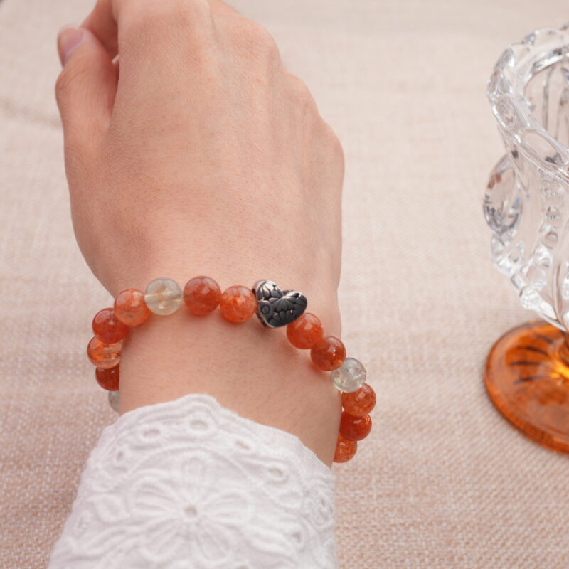 Woman wearing heart-shaped rutile quartz bracelet – minimalist energy jewelry