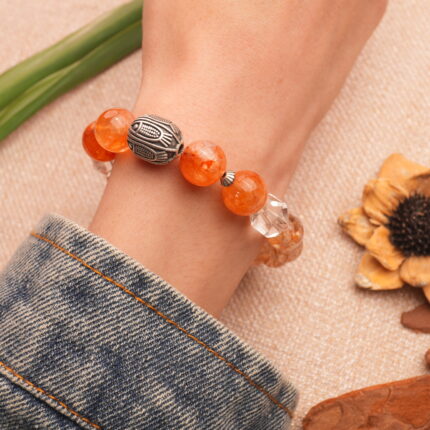 Super Seven Bracelet worn on wrist, showcasing vibrant gemstones in natural light.