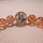Close-up of Super Seven Bracelet showing gemstone textures and Clear Quartz details.
