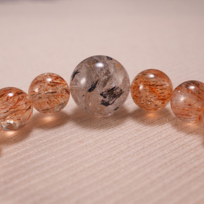 Close-up of Super Seven Bracelet showing gemstone textures and Clear Quartz details.