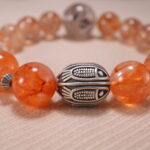Close-up of Super Seven Bracelet showing gemstone textures and Clear Quartz details.