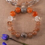 Super Seven Bracelet placed on a natural surface with sunlight highlighting its crystals.