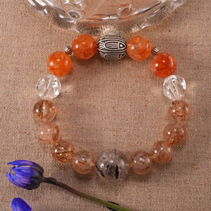 Super Seven Bracelet placed on a natural surface with sunlight highlighting its crystals.