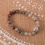 Bracelet placed in a calming, natural setting symbolizing renewal and strength