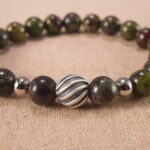 Close-up of smooth Bloodstone beads strung tightly for durability