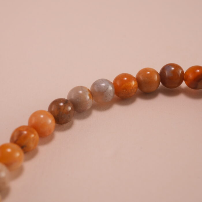 Close-up of landscape stone beads and sterling silver clasp on bracelet