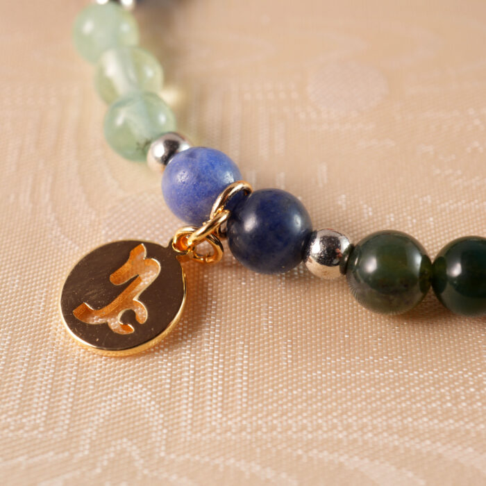 Close-up of gemstone beads and elastic cord on Capricorn bracelet