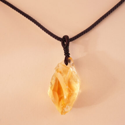 Close-up of woven wrapping around natural citrine crystal