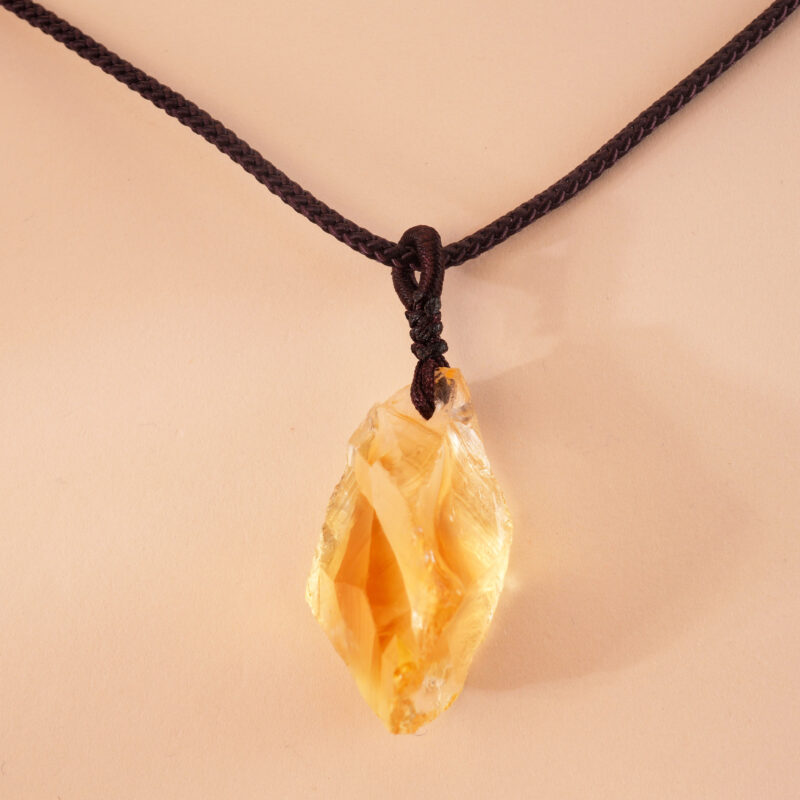 Close-up of woven wrapping around natural citrine crystal