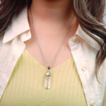 Model wearing the pendant against skin, showing clarity and purity of the stone