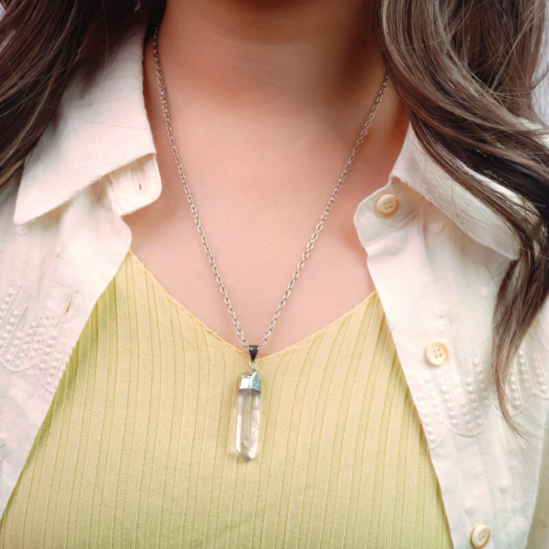 Model wearing the pendant against skin, showing clarity and purity of the stone