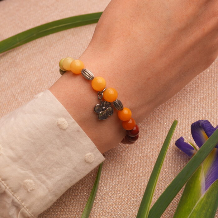 Model wearing colourful beaded flower charm bracelet, stylish and vibrant look