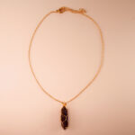Handmade dream amethyst point pendant necklace on a clean white or neutral background