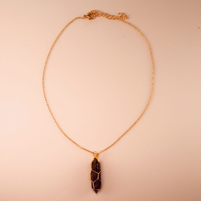 Handmade dream amethyst point pendant necklace on a clean white or neutral background