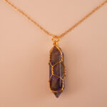 Close-up of dream amethyst’s banded purple & white patterns in a polished point