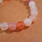 Close-up of 8mm red agate and white chalcedony beads with sterling silver accents