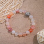 Chalcedony and red agate bracelet placed beside natural light – vibrant and grounding accessory