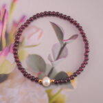 Garnet and pearl bracelet styled with creative workspace items