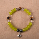 Trio crystal bracelet featuring chalcedony, tiger eye, and clear quartz arranged in a balanced design
