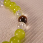 Close-up of the bracelet’s natural stone textures and shining charm details
