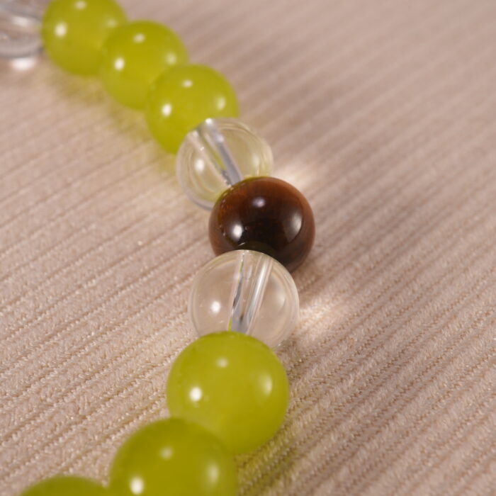 Close-up of the bracelet’s natural stone textures and shining charm details