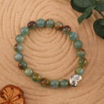 The bracelet placed in a gentle natural setting, surrounded by soft light and calming tones.