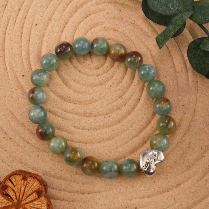 The bracelet placed in a gentle natural setting, surrounded by soft light and calming tones.
