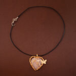 Handmade heart-shaped rose quartz pendant necklace on a soft neutral or white background