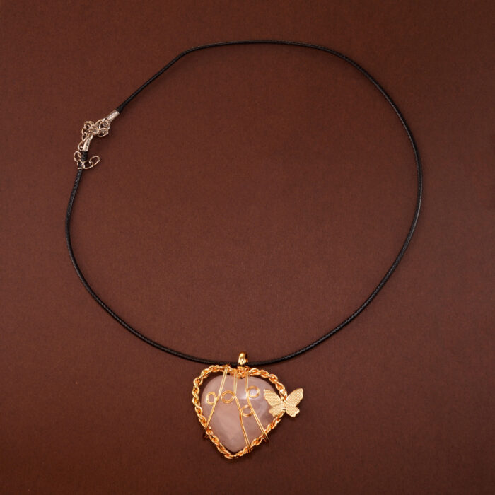 Handmade heart-shaped rose quartz pendant necklace on a soft neutral or white background