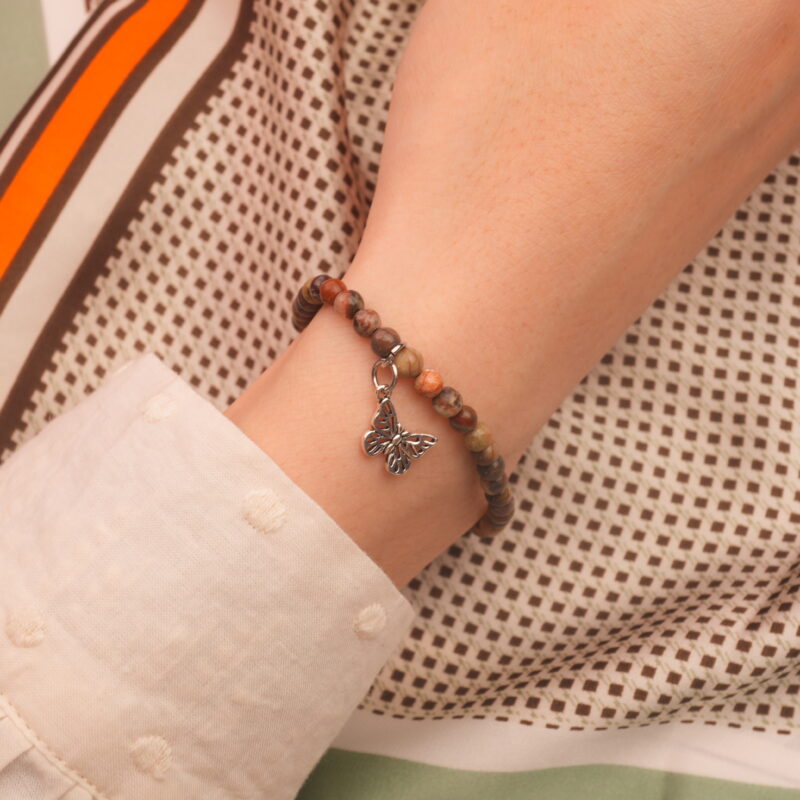 Model wearing jasper gemstone bracelet with Picture Jasper beads