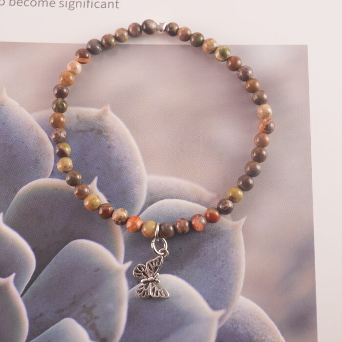 Handcrafted jasper bracelet with Picture Jasper beads displayed in natural setting