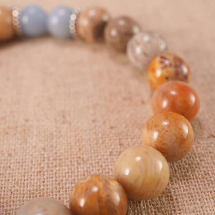 Close-up of Landscape Stone and Blue Chalcedony beads with S925 sterling silver flower charm