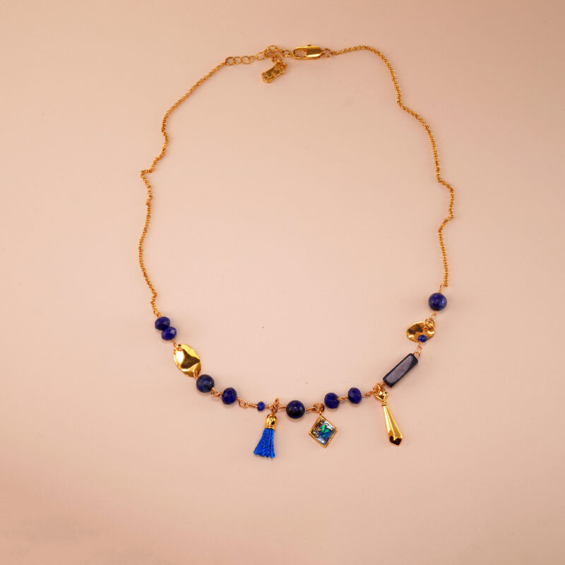 Handmade lapis lazuli pendant necklace centered on a neutral background