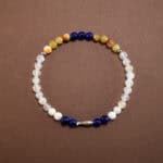 Lapis lazuli and chalcedony bracelet with sterling silver charm on white background