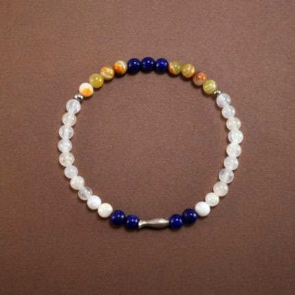 Lapis lazuli and chalcedony bracelet with sterling silver charm on white background