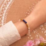 Layered on wrist with neutral-toned clothing, showcasing calming color palette