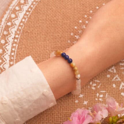 Layered on wrist with neutral-toned clothing, showcasing calming color palette