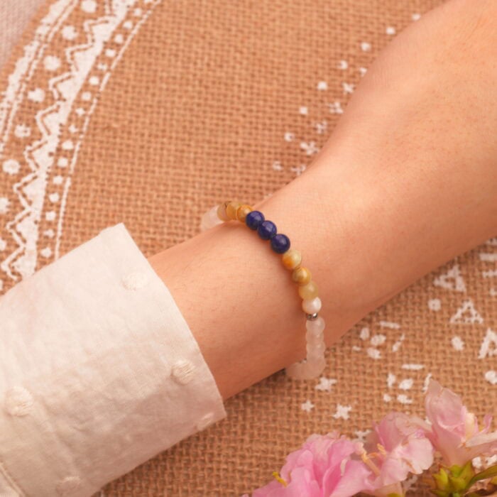 Layered on wrist with neutral-toned clothing, showcasing calming color palette
