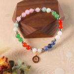 Libra crystal bracelet displayed on a natural wooden surface, representing peace and harmony