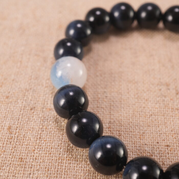 Close-up of Blue Tiger Eye Beads and Fish Charm – 8mm Gemstone Bracelet for Clarity and Energy