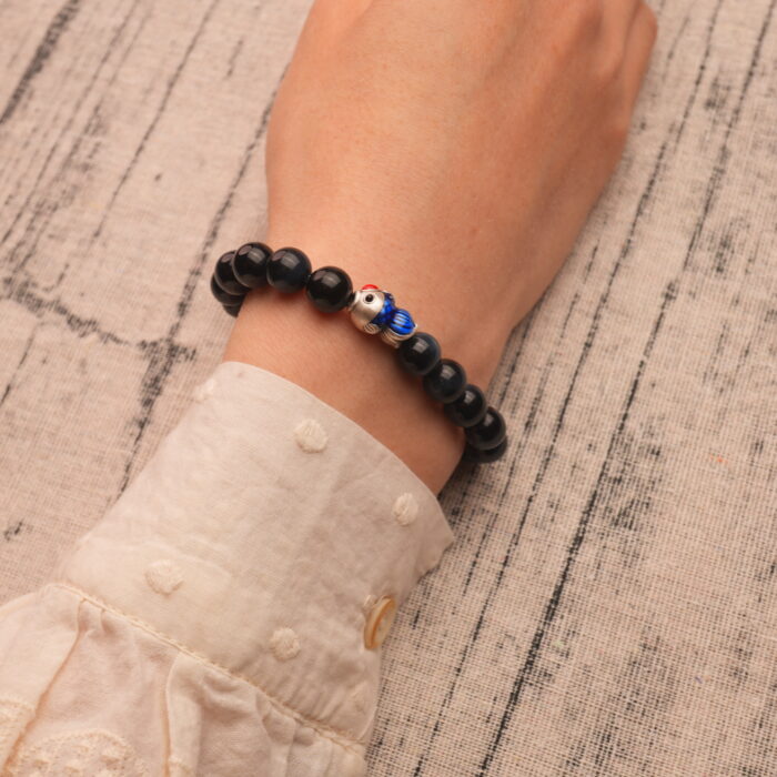 Wearing Blue Tiger Eye Bracelet with Silver Fish Charm – 8mm Crystal Jewelry for Calm and Strength
