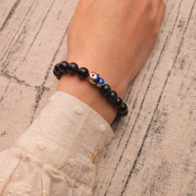 Wearing Blue Tiger Eye Bracelet with Silver Fish Charm – 8mm Crystal Jewelry for Calm and Strength