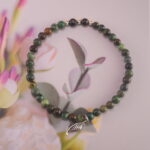 Jade Charm Bracelet on Wooden Background – Symbol of Peace and Growth