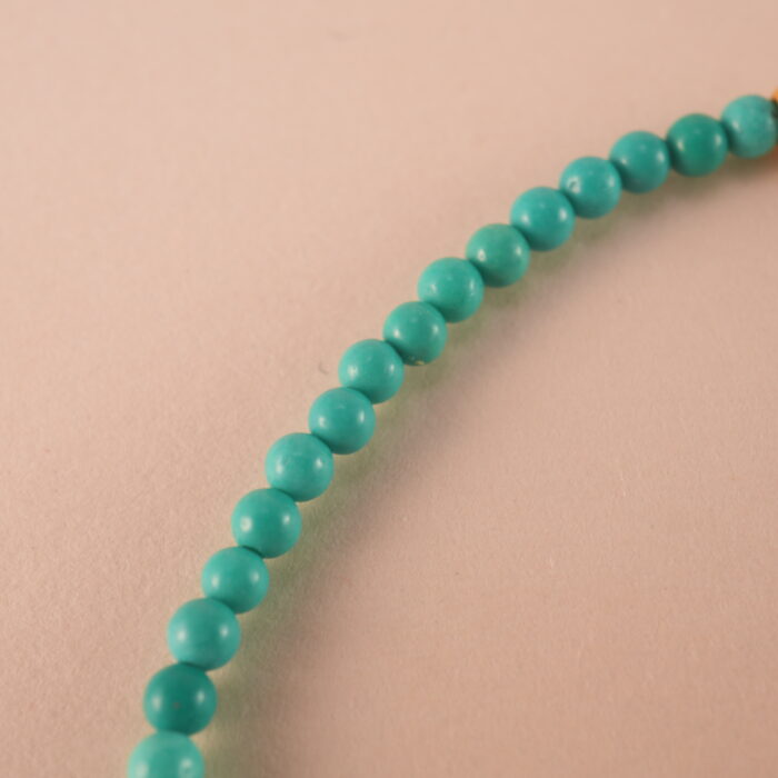 Close-up of natural turquoise beads and knot detail