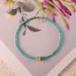 Turquoise bracelet styled on a rustic fabric or wooden tray