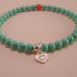 Close-up of turquoise, agate beads, and heart charm