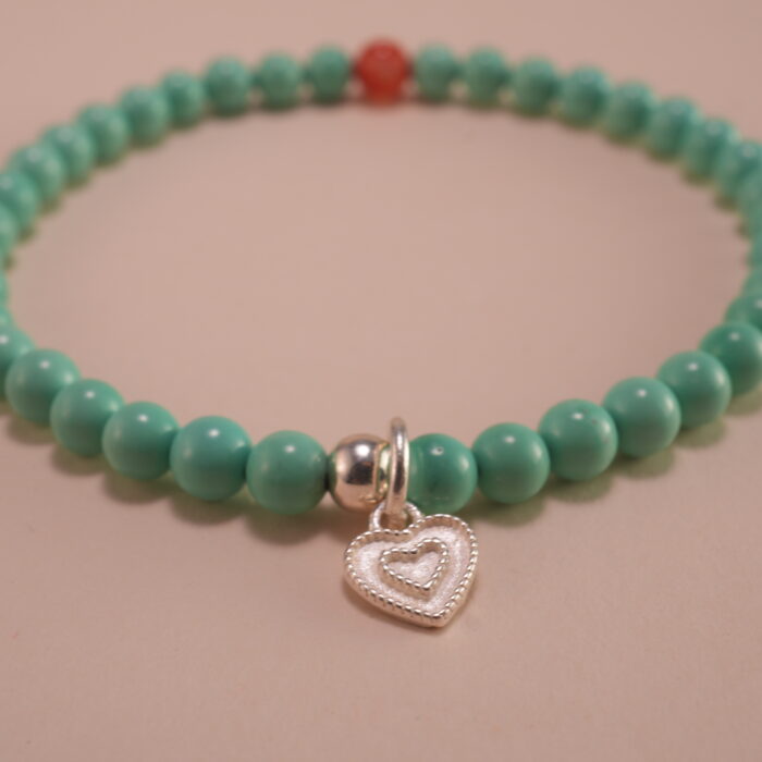 Close-up of turquoise, agate beads, and heart charm